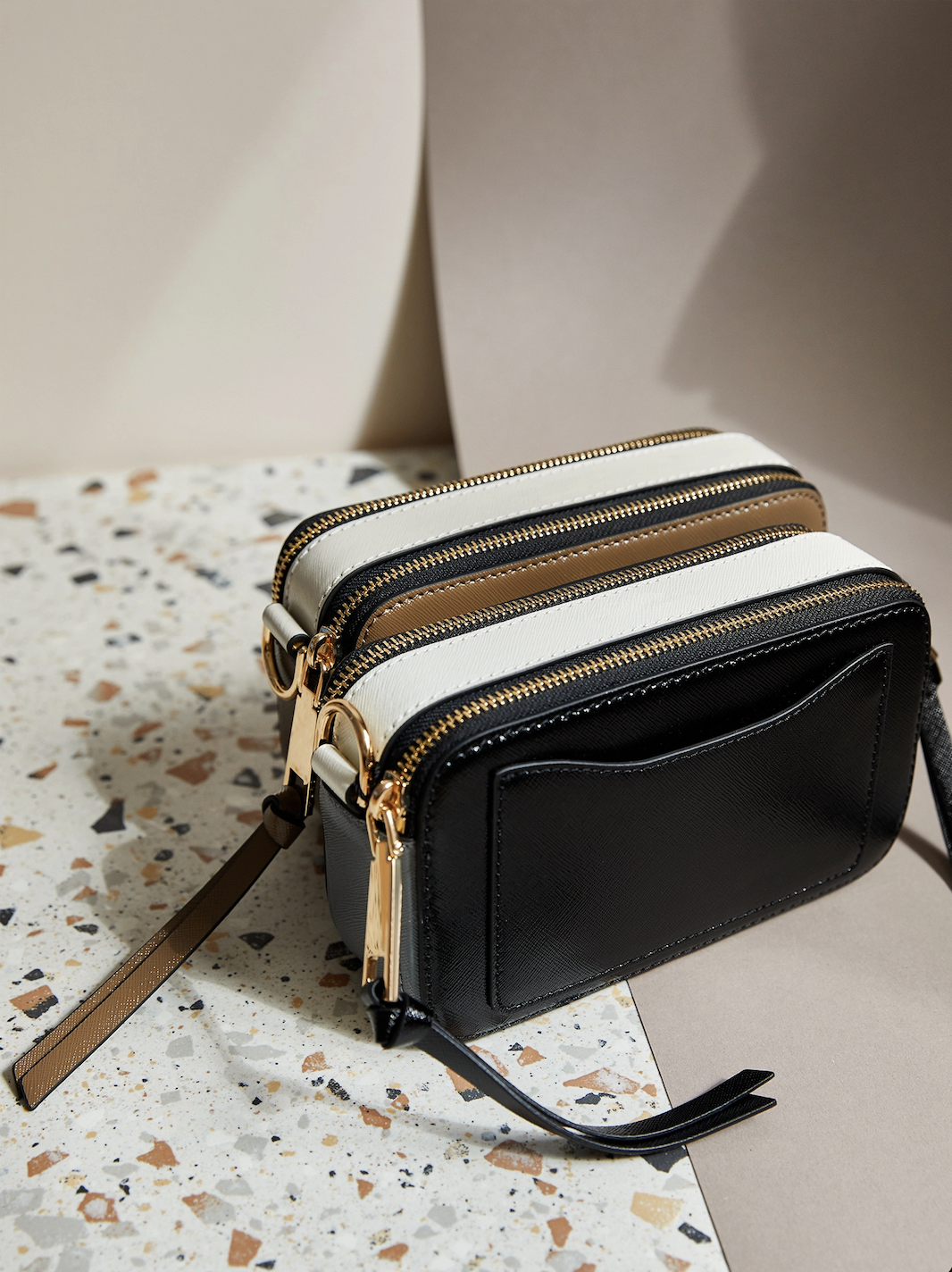 Two small handbags sitting on a bench, illustrating a financial travel checklist tip to prepare a dummy wallet as a decoy to protect real cash and cards while travelling overseas.