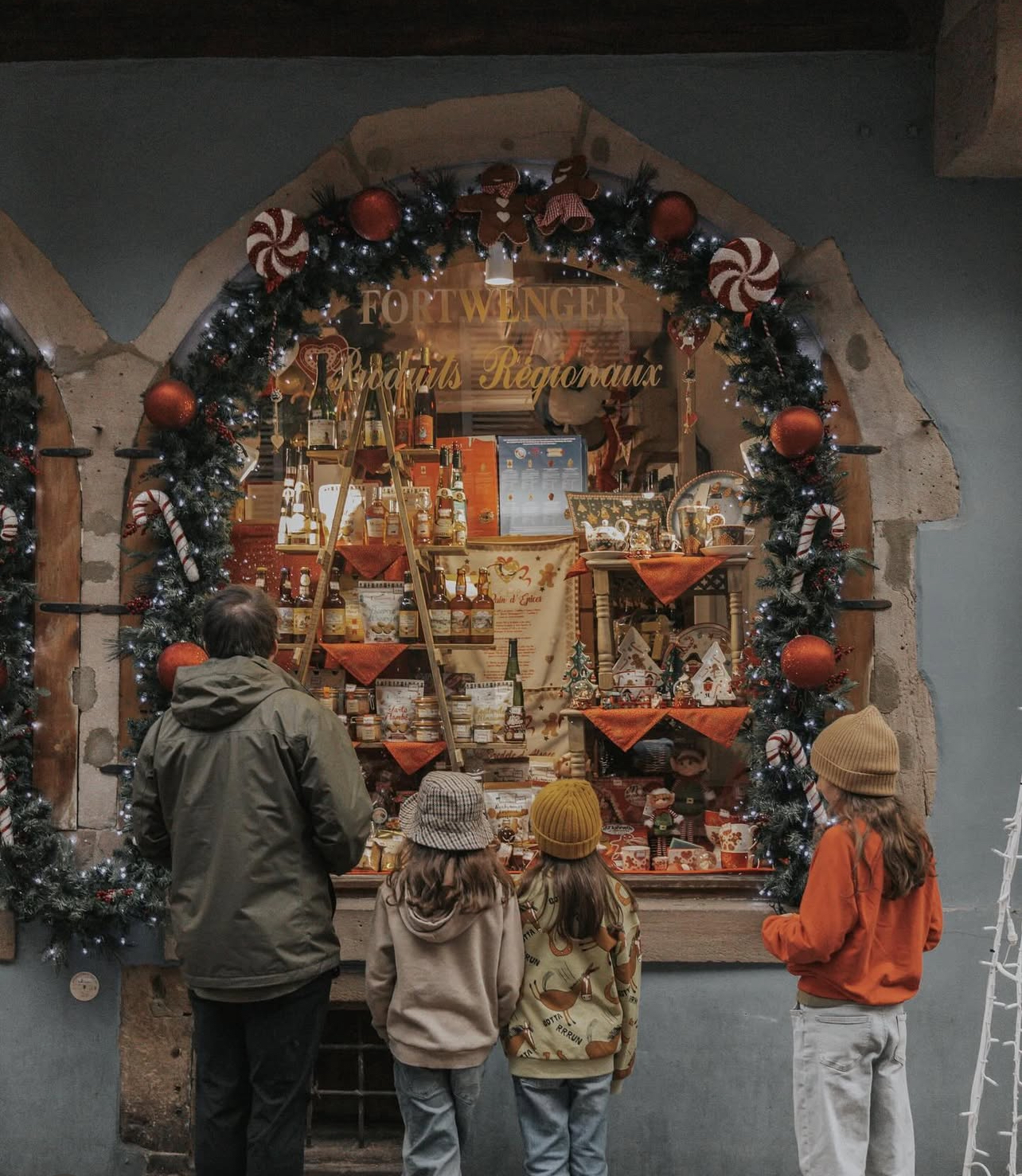 Dad and children wandering through Colmar Christmas markets in France, where both cash and card options were offered.